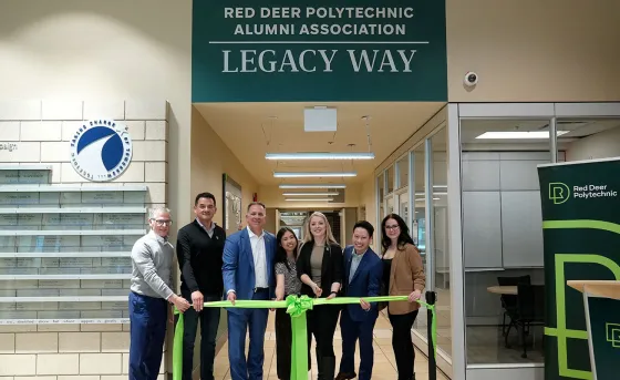 Representatives from RDP and the Alumni Association cut a ribbon to celebrate the opening of Red Deer Polytechnic Alumni Legacy Way on main campus 