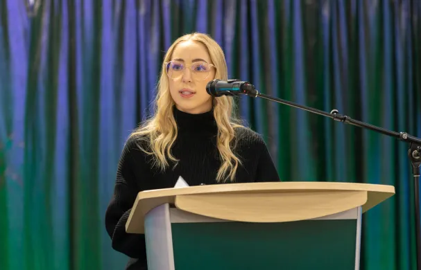 Student presenting at podium