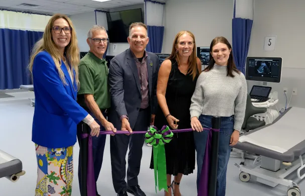 Members of RDP's executive team and Sonography program cutting the ribbon at new lab