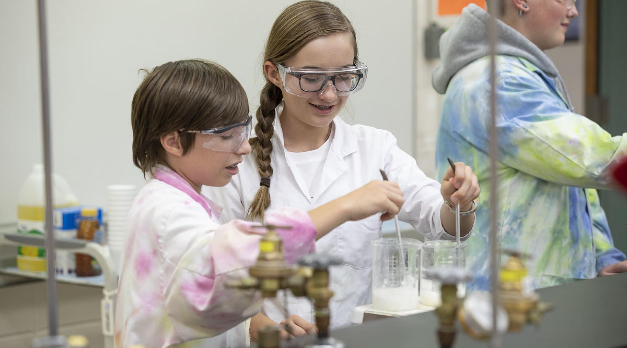Two children doing experiment in science lab