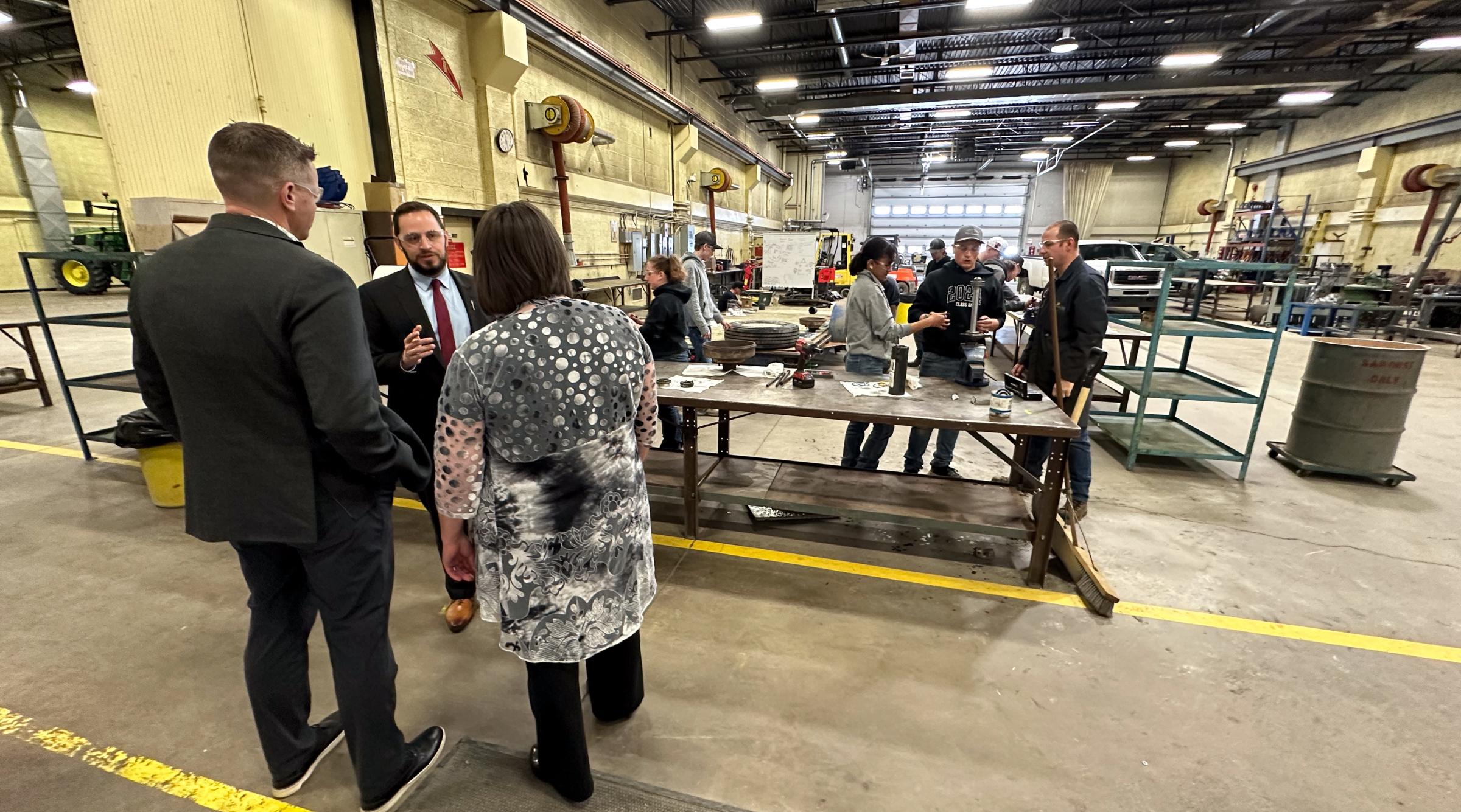 Minister Nicolaides chatting with some folks in a large workshop