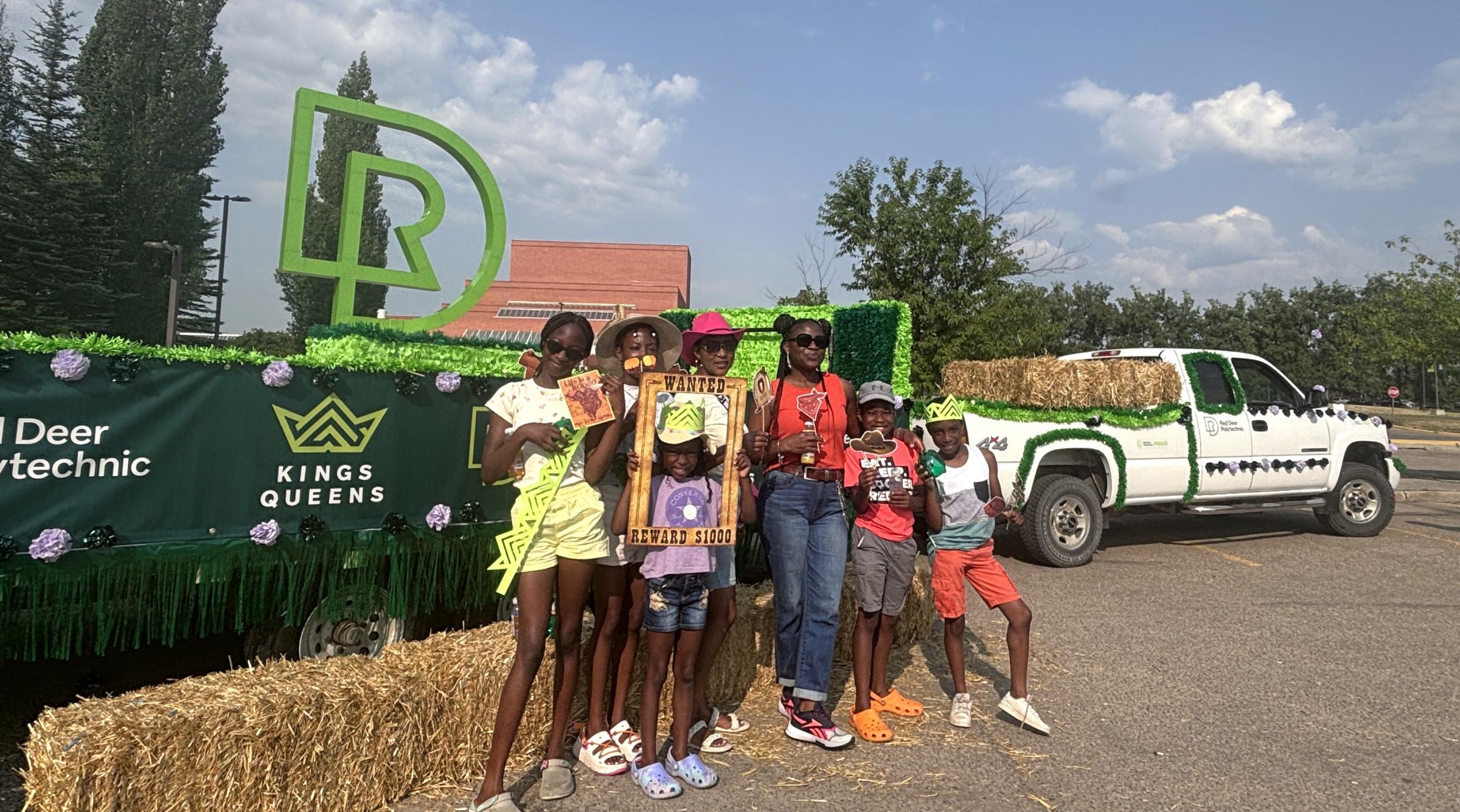 A family stands in front of the RDP parade float