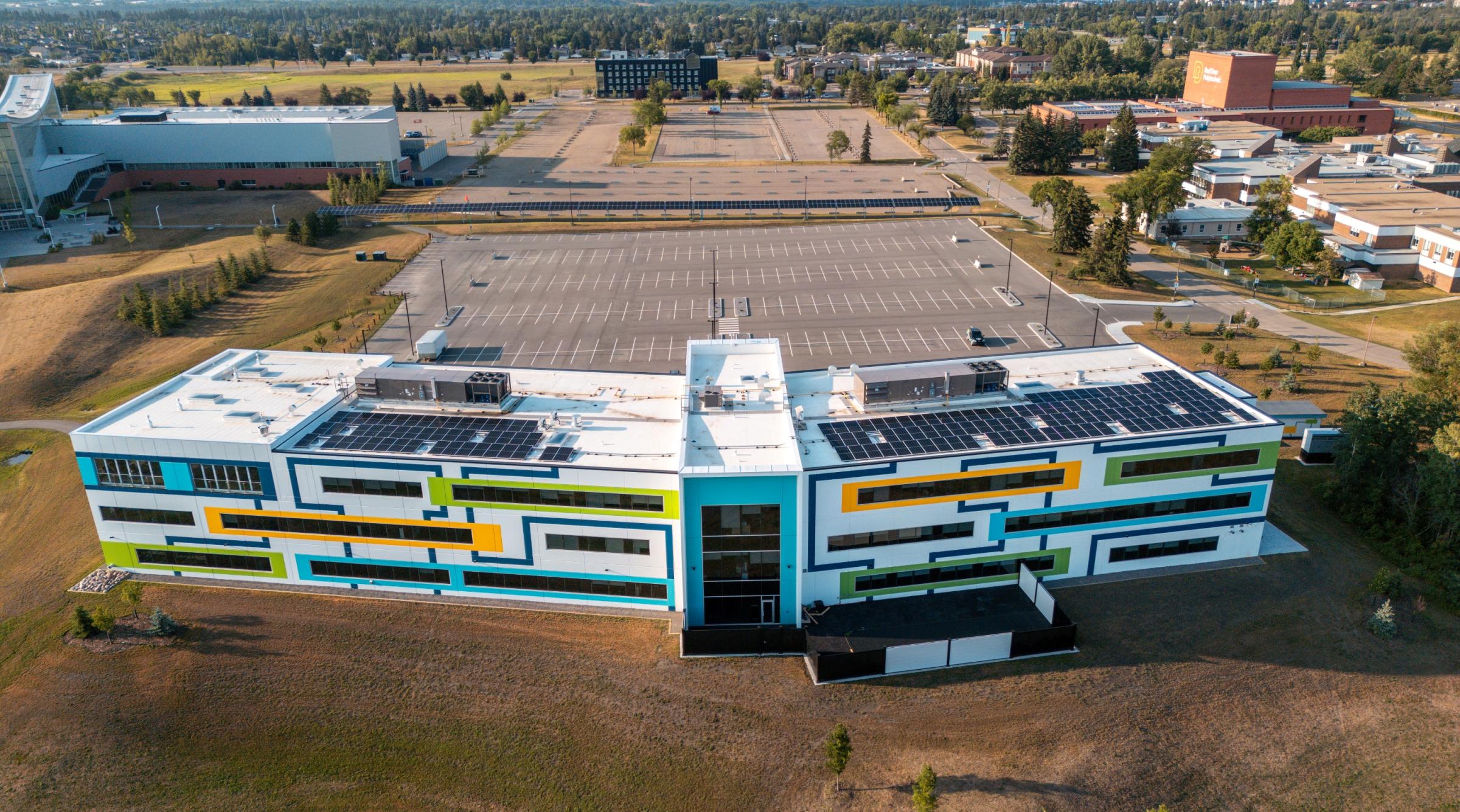 an aerial shot looking down at the multi-coloured CACAC building called the Sheldon Kennedy Centre of Excellence