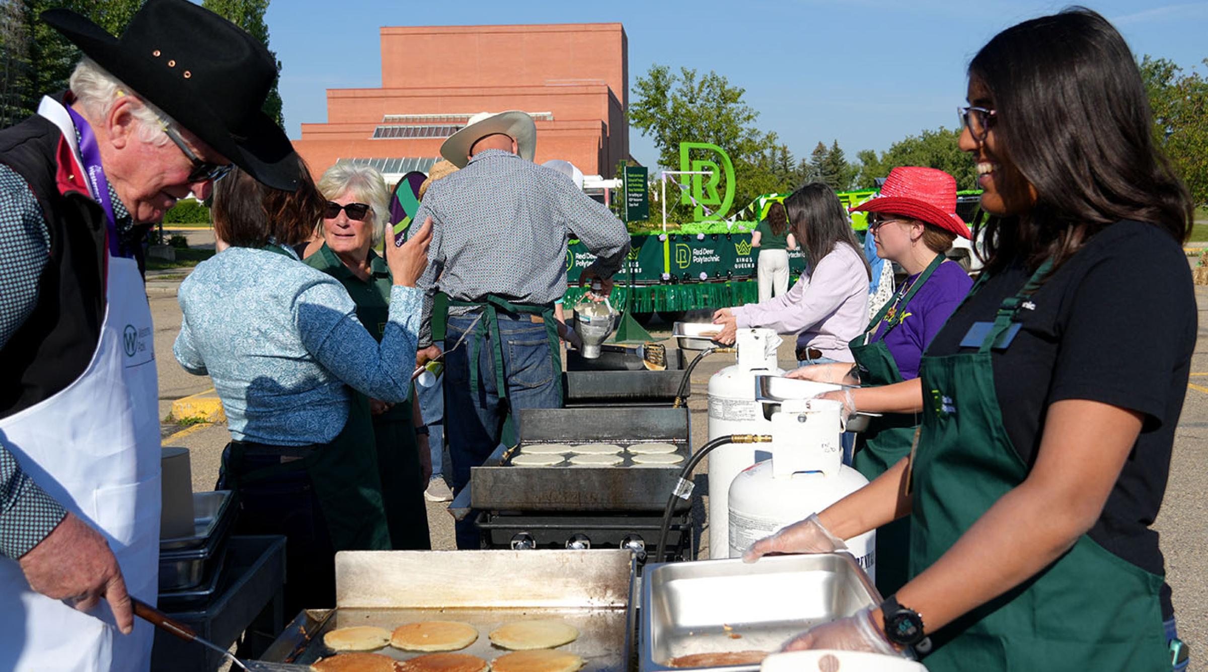 People flipping pancakes at RDP's Westerner Days Pancake Breakfast on July 18