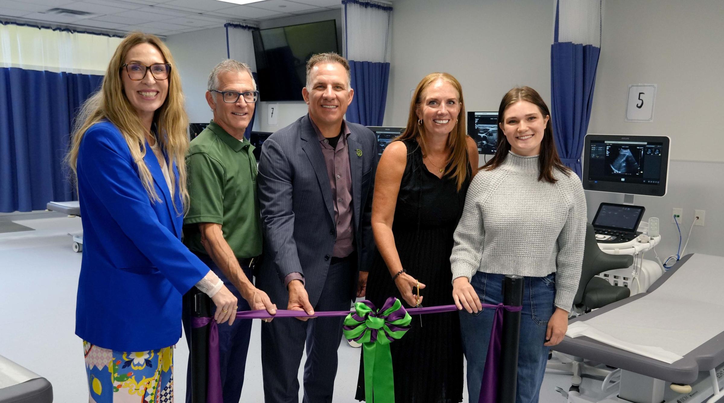 Members of RDP's executive team and Sonography program cutting the ribbon at new lab
