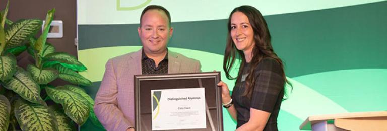 Kaun accepting distinguished alum award