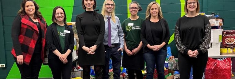 Employees from across RDP pose for a picture in front of the food donated