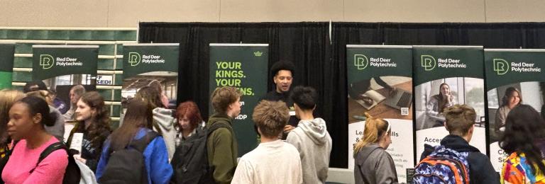 Group of students lines up in front of a both showcasing Red Deer Polytechnic programs