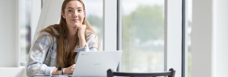 Girl at table on laptop