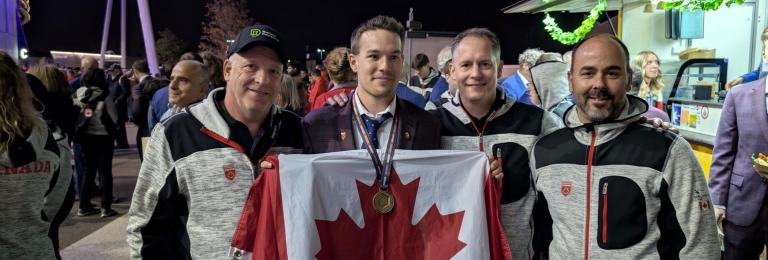 Ben Rainforth with Coach and RDP faculty, Lee Yasinski holding bronze medal and Canadian flag at WorldSkills competition