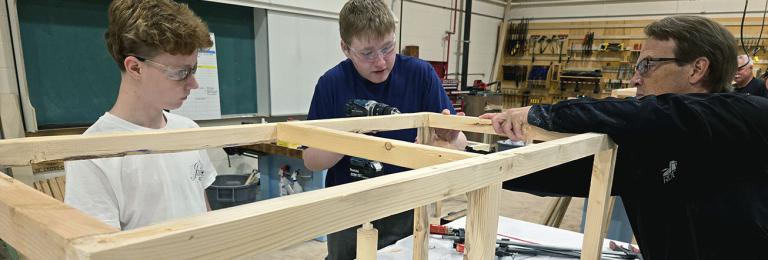 Students are assisted by an RDP instructor as they build a potato planter