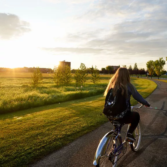 student biking on campus