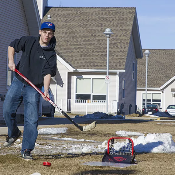 students outside shooting a puck