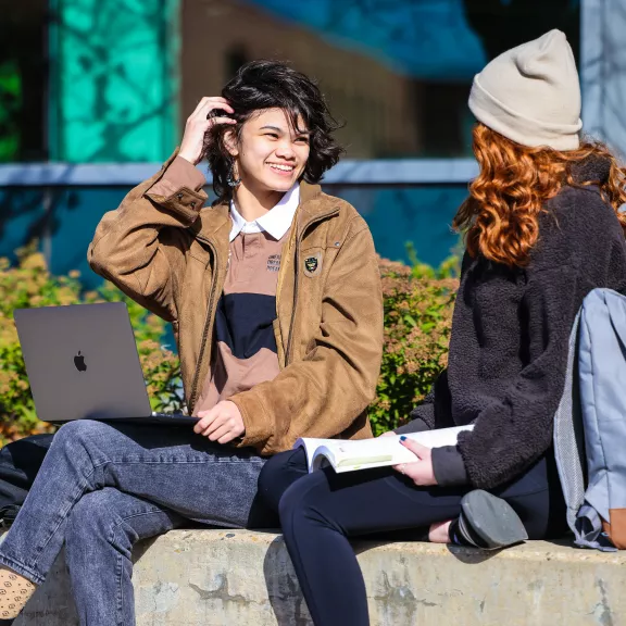 two students sitting outside