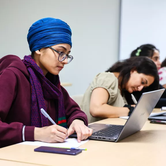 Students working on laptops side by side.