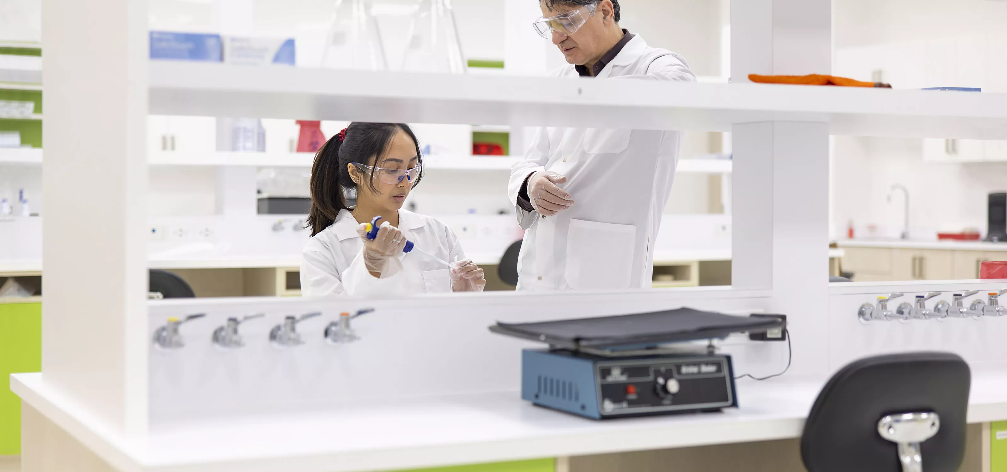 Instructor helping student in biology lab