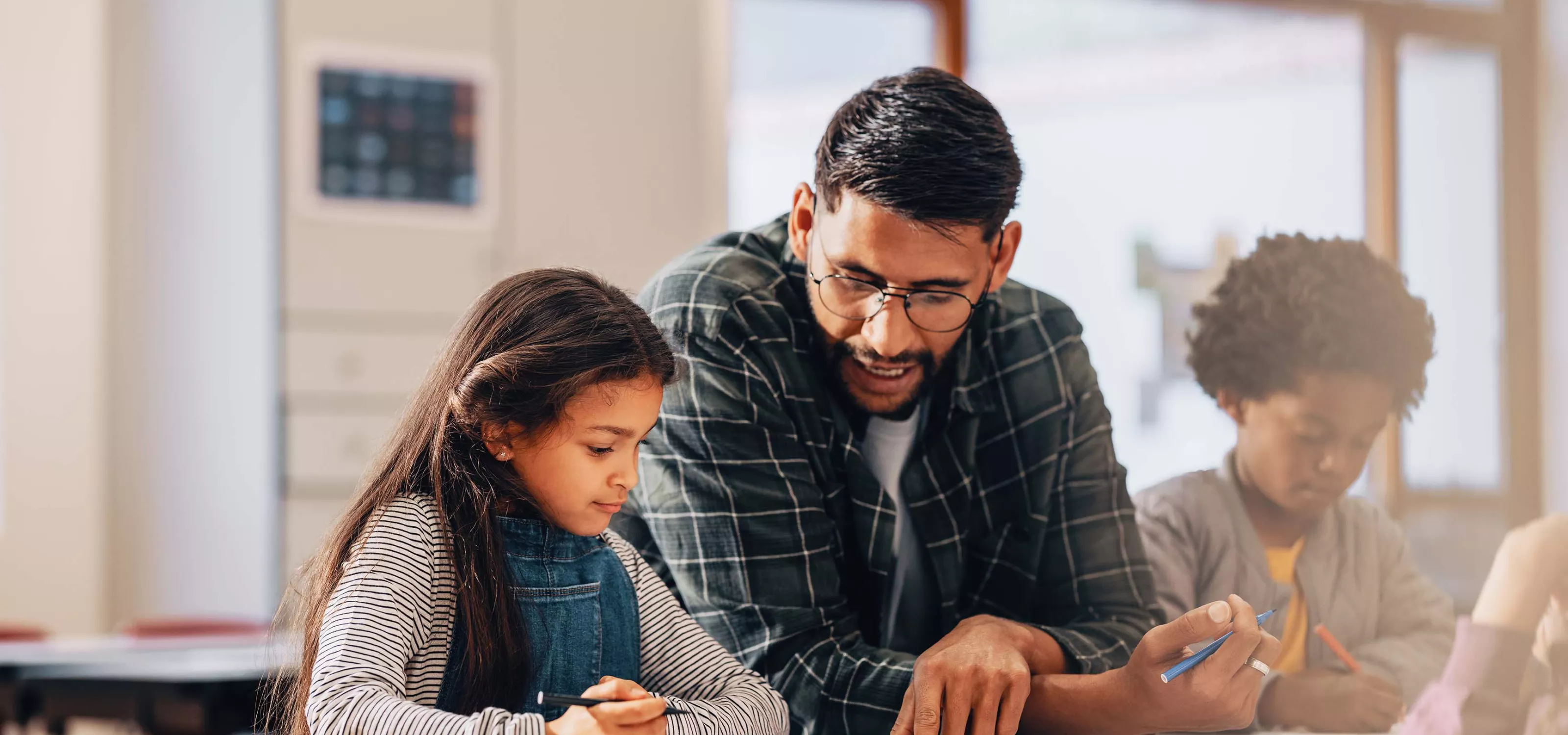 Male teacher with two young students